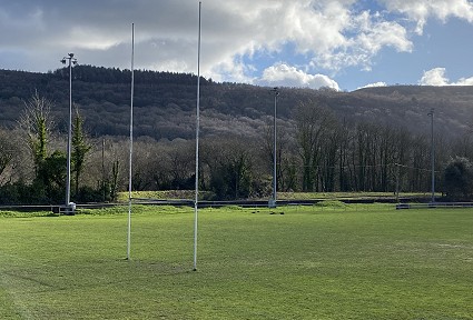 rugby feild with post and mountaind in the background