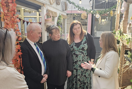 Sioned Williams MS is with the leader of Neath Port Talbot Council and the Cabinet Secretary from Welsh Government. They are standing in Neath Market