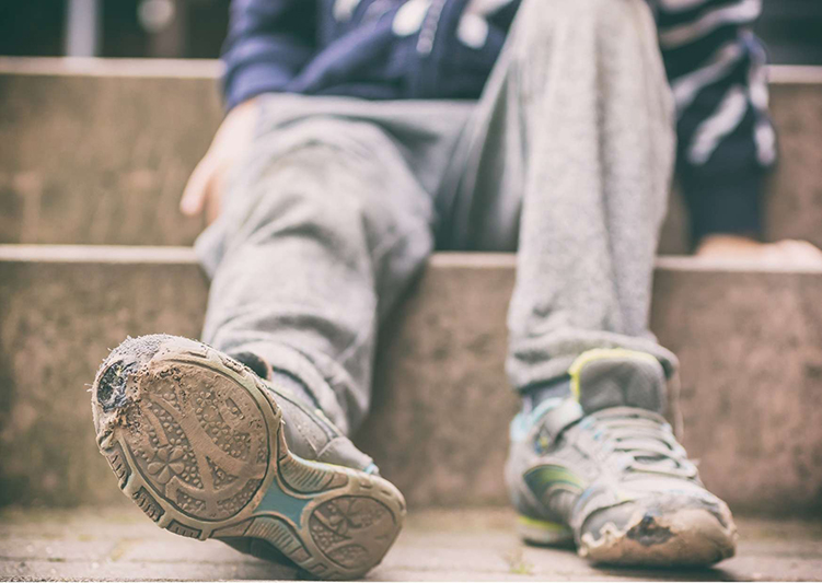 Man wearing broken trainers