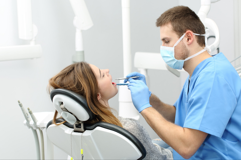 dentist using equipment in a patients mouth