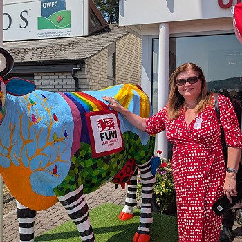 Sioned next to a colourful model of a cow