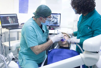 Dentist and nurse inspecting  patients mouth