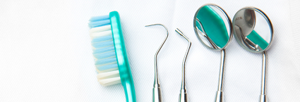 Tootbrush and dental instruments in white coat pocket