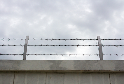 Barbed wire on top of a wall