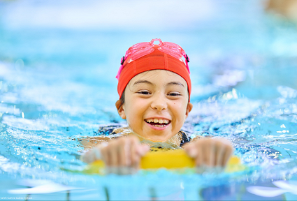 A child is swimming in a swimming pool