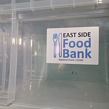 Plastic box and a sign for the East Side Food Bank