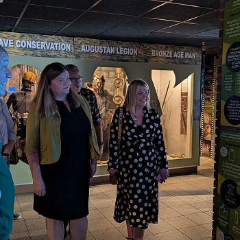 Sioned and Beca with hosts looking at an exhibition